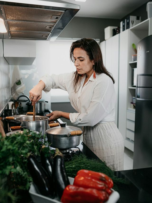 A woman cooking dinner at the stove